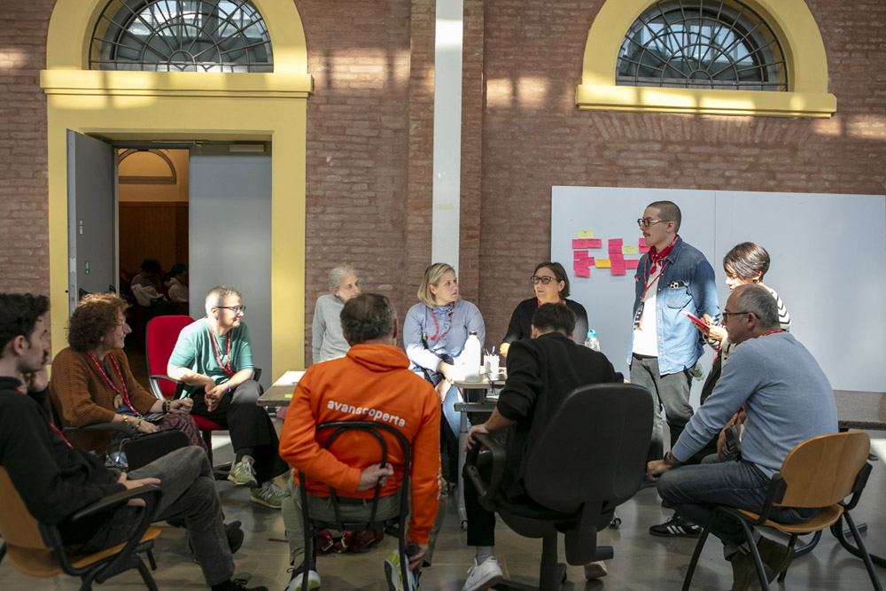 Gruppo di partecipanti durante un workshop aziendale con post-it e lavagna